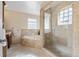 Luxurious bathroom with a glass shower and soaking tub with stone tile, plus a large vanity at 2400 S Clayton St, Denver, CO 80210