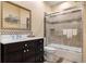 Bathroom features tiled shower with glass door, dark vanity, and decorative mirror at 2400 S Clayton St, Denver, CO 80210