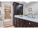 Modern bathroom featuring dual sinks, marble countertops, and dark wood cabinets at 2400 S Clayton St, Denver, CO 80210