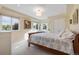 Sunlit bedroom with bed, white walls, multiple windows, and traditional furnishings at 2400 S Clayton St, Denver, CO 80210
