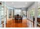 Sunlit dining room featuring hardwood floors, built-in shelves, and French doors leading to the outside at 2400 S Clayton St, Denver, CO 80210