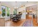Bright dining area with a rustic wooden table, a view of the backyard, and hardwood flooring at 2400 S Clayton St, Denver, CO 80210