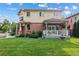 Beautiful two-story home with a well-maintained lawn, covered porch, and classic American flag waving proudly at 2400 S Clayton St, Denver, CO 80210