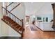 Hallway with hardwood flooring, a staircase, and a view into a living room with lots of natural light at 2400 S Clayton St, Denver, CO 80210