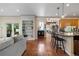 Open living room with hardwood floors, built-in shelving, and seamless flow to kitchen and outdoor space at 2400 S Clayton St, Denver, CO 80210