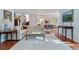 Open-concept living space featuring hardwood floors, neutral decor, and seamless flow into the dining area at 2400 S Clayton St, Denver, CO 80210