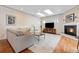 Cozy living room with skylights, a fireplace, hardwood floors, and comfortable seating perfect for relaxation at 2400 S Clayton St, Denver, CO 80210
