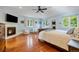 Spacious main bedroom with fireplace, hardwood floors, sitting area, and abundant natural light at 2400 S Clayton St, Denver, CO 80210
