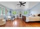 Tranquil main bedroom with hardwood floors, ample windows, sitting area, and built-in shelves at 2400 S Clayton St, Denver, CO 80210