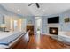 Spacious primary bedroom with a fireplace and a television overlooking the foot of the bed at 2400 S Clayton St, Denver, CO 80210