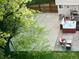 A relaxing backyard features a hot tub, patio seating, and a well-manicured lawn at 4892 S Robb St, Littleton, CO 80127