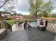 View of a spacious backyard with a hot tub, patio furniture and deck with stairs leading to the yard at 4892 S Robb St, Littleton, CO 80127