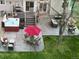 Aerial shot of a well landscaped backyard with a patio, dining table and chairs, and a hot tub at 4892 S Robb St, Littleton, CO 80127