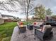 Spacious backyard with a patio, multiple seating areas, a fire pit, and ample green space at 4892 S Robb St, Littleton, CO 80127