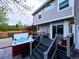 Exterior view of a well-maintained backyard showcasing a hot tub, deck with outdoor seating, and yard at 4892 S Robb St, Littleton, CO 80127