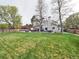 Expansive backyard with manicured lawn, patio area, hot tub, dining set, and seating for entertaining at 4892 S Robb St, Littleton, CO 80127