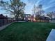 Expansive backyard with lush lawn, mature trees, and patio area for outdoor living and entertaining at 4892 S Robb St, Littleton, CO 80127
