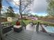 Deck overlooks a large backyard with a hot tub and patio furniture at 4892 S Robb St, Littleton, CO 80127