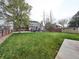 Spacious backyard with a large lawn, patio area, and wooden storage shed, great for outdoor activities at 4892 S Robb St, Littleton, CO 80127