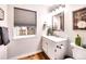Charming half bathroom with a modern vanity, a stylish mirror, a decorative house plant and nice accents at 4892 S Robb St, Littleton, CO 80127