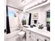 This bathroom offers a tub, shower, a rounded window, and modern fixtures at 4892 S Robb St, Littleton, CO 80127