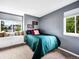 Bedroom features a window seat beneath the window and neutral walls at 4892 S Robb St, Littleton, CO 80127