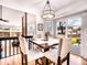 Dining area with a dark wood table, beige upholstered chairs, and modern lighting at 4892 S Robb St, Littleton, CO 80127
