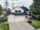 Charming two-story home featuring a well-maintained lawn and a convenient three-car garage at 4892 S Robb St, Littleton, CO 80127