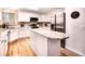 Bright kitchen features white cabinets, stainless steel appliances, and granite countertops at 4892 S Robb St, Littleton, CO 80127