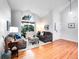 Bright living room featuring vaulted ceiling, hardwood floors, and large windows at 4892 S Robb St, Littleton, CO 80127