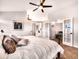 Bright main bedroom featuring a ceiling fan, ensuite, and walk-in closet at 4892 S Robb St, Littleton, CO 80127