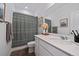 Well-lit bathroom featuring modern fixtures, a single vanity, and a patterned shower curtain at 430 Millwall Cir, Castle Pines, CO 80108