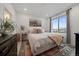 Bright bedroom with a comfortable bed, decorative rug, and a large window at 430 Millwall Cir, Castle Pines, CO 80108