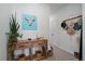 Decorated hallway with a wooden console table, plants, and rustic accents at 430 Millwall Cir, Castle Pines, CO 80108