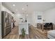 Modern kitchen with stainless steel appliances, white cabinets, a center island, and adjacent dining area at 430 Millwall Cir, Castle Pines, CO 80108