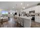 Open kitchen with island seating, stainless steel appliances, and seamless flow to the living space at 430 Millwall Cir, Castle Pines, CO 80108