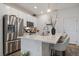 Bright kitchen with a large island, stainless steel appliances, and white cabinets at 430 Millwall Cir, Castle Pines, CO 80108