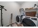 Laundry room featuring modern washer and dryer, shelving, and decor at 430 Millwall Cir, Castle Pines, CO 80108