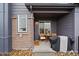 Cozy front patio with a table, chairs, and grill under a covered porch at 430 Millwall Cir, Castle Pines, CO 80108