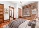 Bedroom with exposed brick accent wall, hardwood floors, and neutral colored rug at 1210 E Colfax Ave # 302, Denver, CO 80218