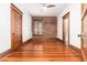 Bedroom boasting exposed brick wall, ceiling fan, hardwood floors and three doorways at 1210 E Colfax Ave # 302, Denver, CO 80218