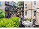 Charming courtyard with fire pit, seating area, and lush landscaping at 1210 E Colfax Ave # 302, Denver, CO 80218