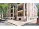 Classic multi-story brick apartment building with beautiful balconies and street view at 1210 E Colfax Ave # 302, Denver, CO 80218