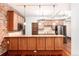 Modern kitchen with granite countertops, stainless steel appliances, and exposed brick accents at 1210 E Colfax Ave # 302, Denver, CO 80218