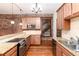 Contemporary kitchen featuring granite countertops, stainless steel appliances, and exposed brick wall at 1210 E Colfax Ave # 302, Denver, CO 80218