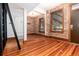 Bright living room with hardwood floors, exposed brick and large windows at 1210 E Colfax Ave # 302, Denver, CO 80218