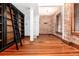 Bright living room with hardwood floors, exposed brick and bookshelf at 1210 E Colfax Ave # 302, Denver, CO 80218