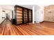 Spacious living room featuring hardwood floors and custom built-in shelving at 1210 E Colfax Ave # 302, Denver, CO 80218