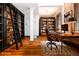 Office with wooden floors, bookshelves and a desk by the window at 1210 E Colfax Ave # 302, Denver, CO 80218