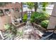 Private patio surrounded by lush landscaping with seating and an outdoor dining area at 1210 E Colfax Ave # 302, Denver, CO 80218
